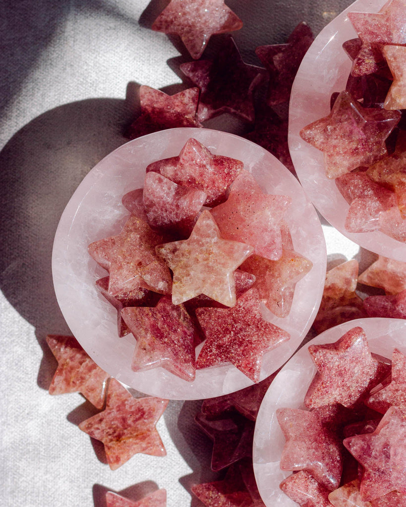 Deep color strawberry quartz star crystals with natural inclusions and a glossy polished surface