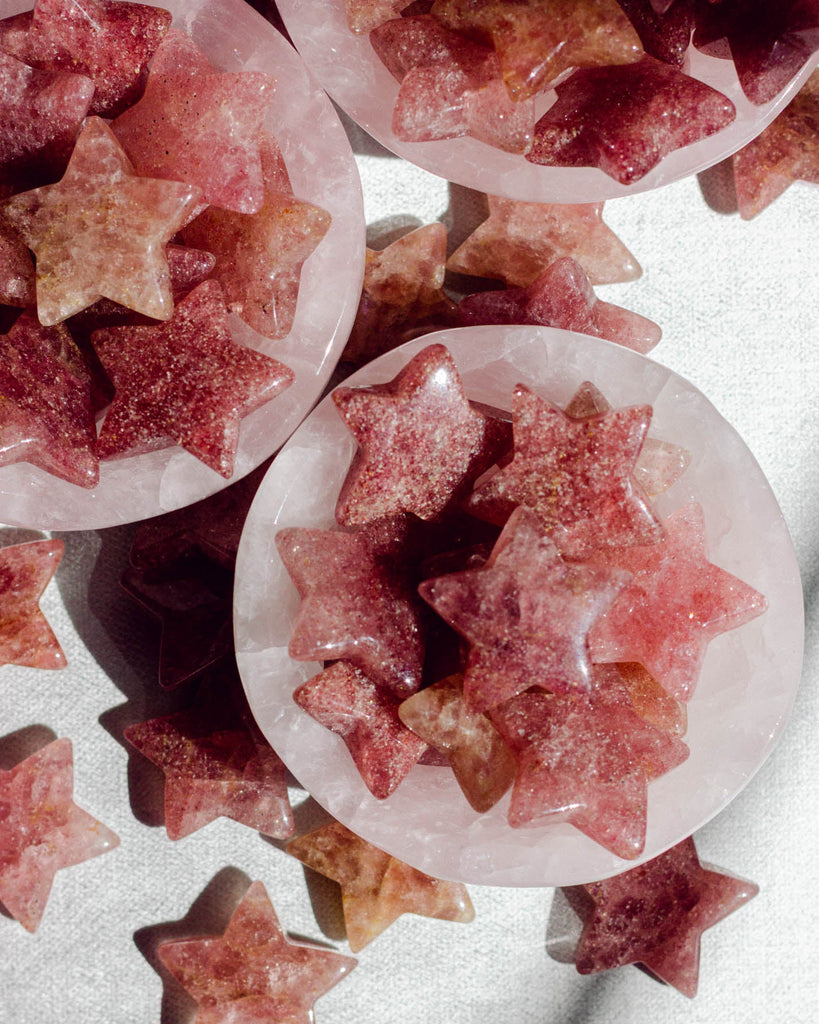 Hand-shaped strawberry quartz stars in warm pink and reddish hues, perfect for decor or crystal displays