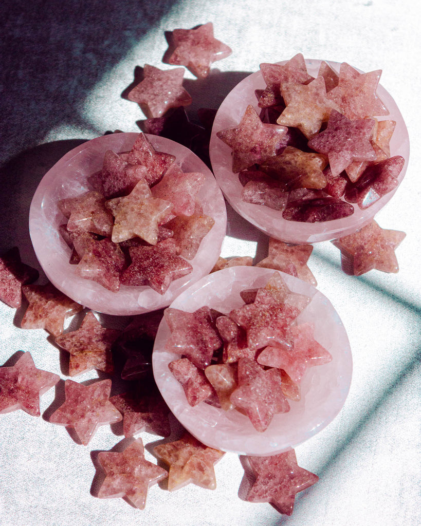 Polished strawberry quartz crystal stars in rosy pink and golden undertones, radiating gentle energy.