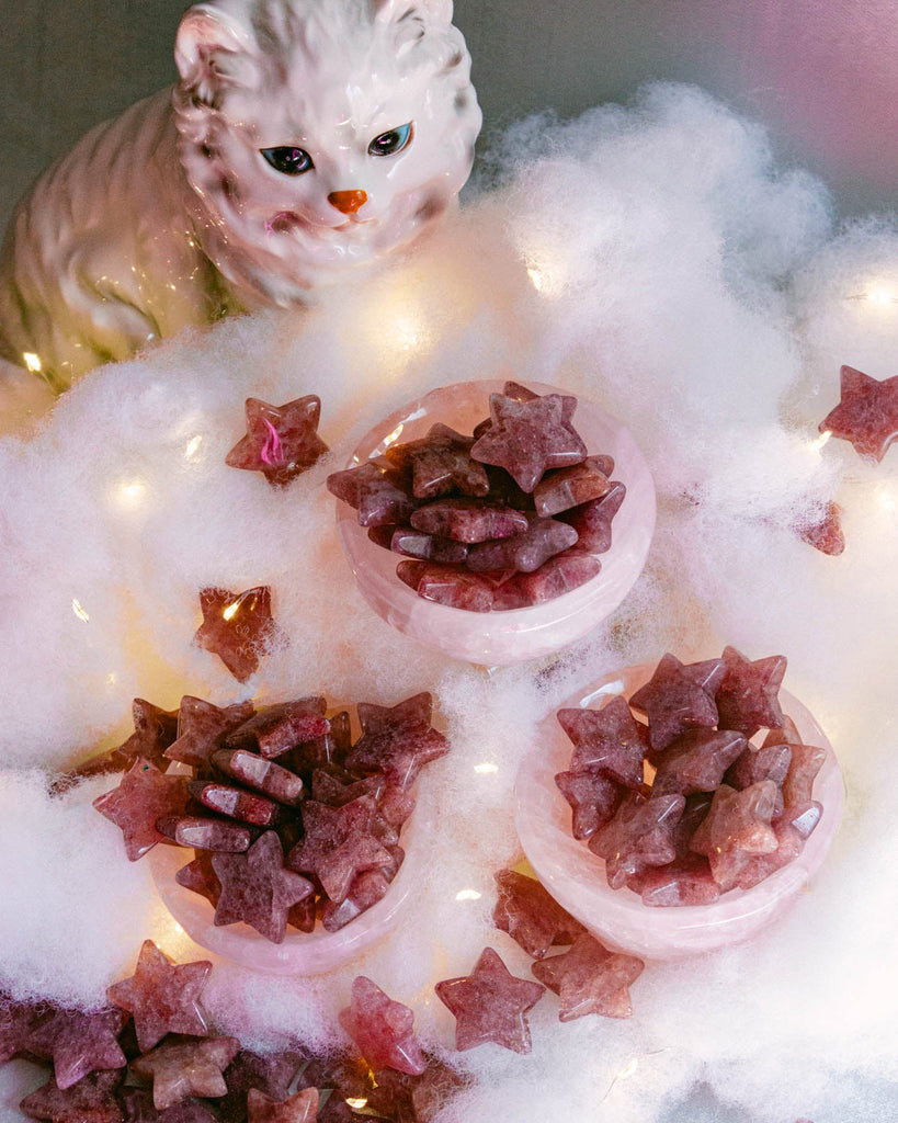 Polished strawberry quartz crystal stars in deep rose and pink-red tones, hand-carved for decor or gifting.