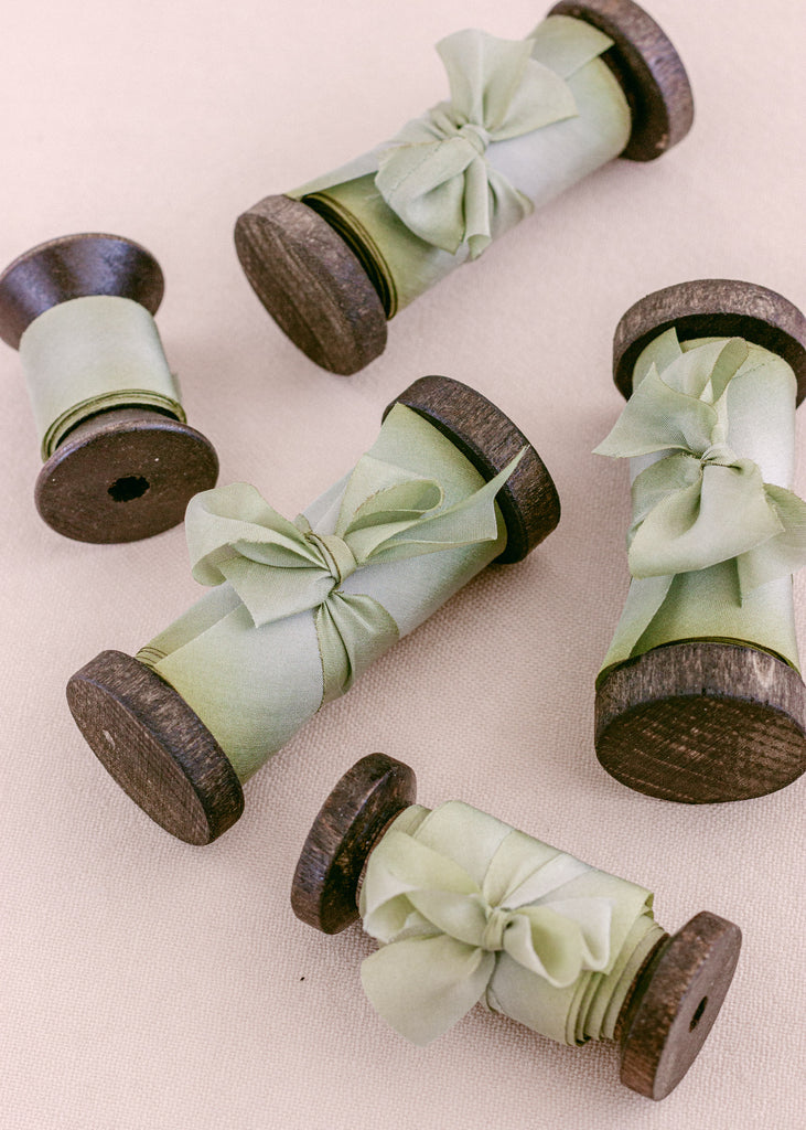 hand dyed light green silk ribbon on wood spools