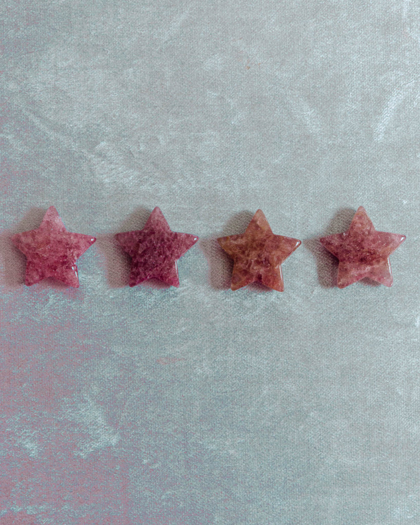 Strawberry quartz stars showing rich strawberry-red hues and natural quartz texture under soft lighting.