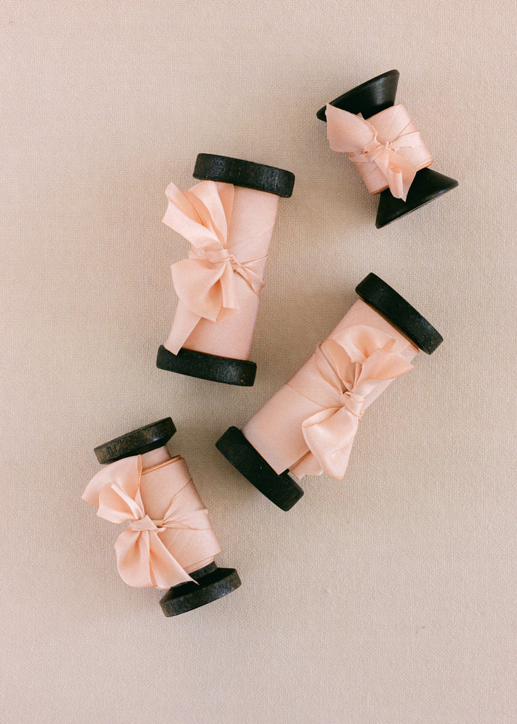 peach silk ribbon on wood spools 