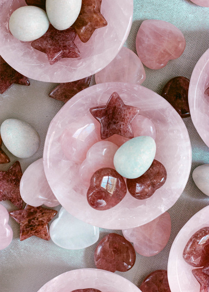 Natural crystal gift set featuring polished rose quartz, strawberry quartz, and blue calcite stones in a pink bowl