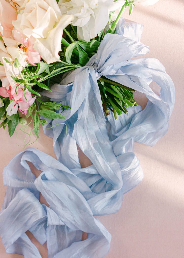 Soft French blue silk ribbon for tying around wedding invitations, bouquets, and table décor accents