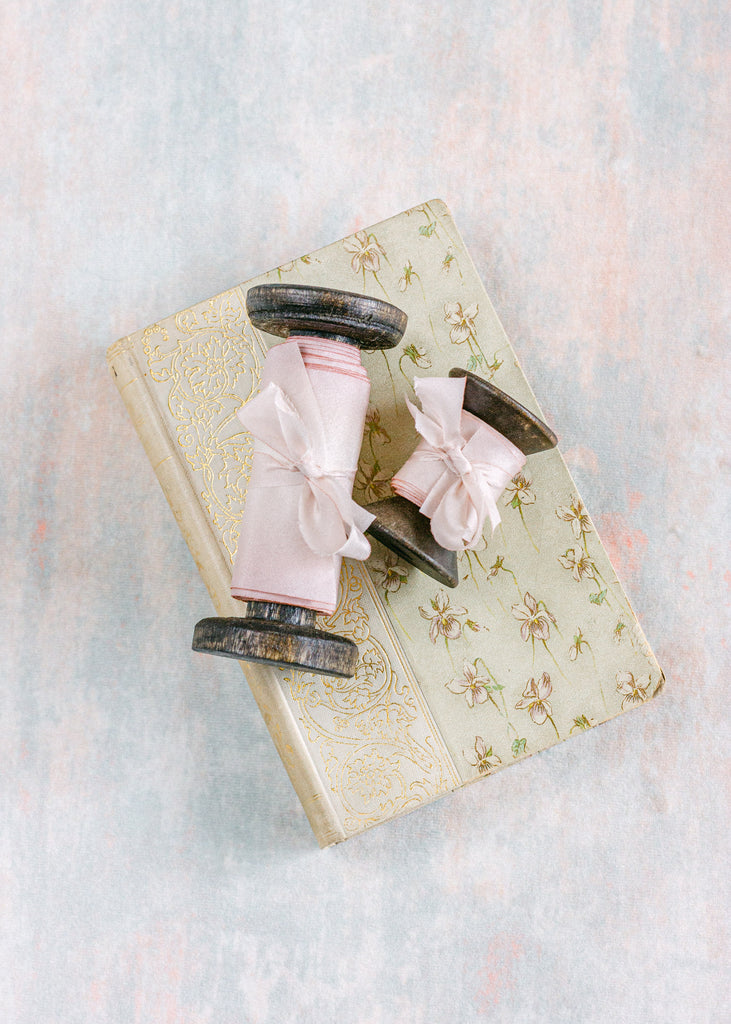 Soft pastel pink silk ribbon for wedding invitations, bridal shower décor, and elegant table styling
