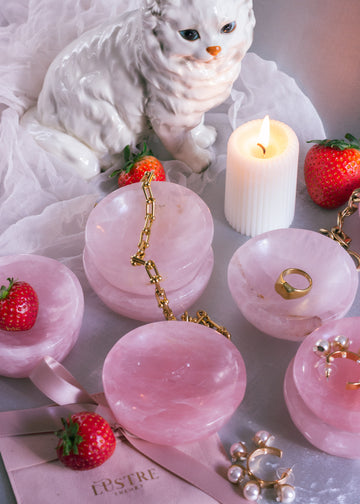 Hand-carved natural pink Rose Quartz trinket dishes with gold jewelry with smooth polished surface, perfect for holding jewelry or small treasures.